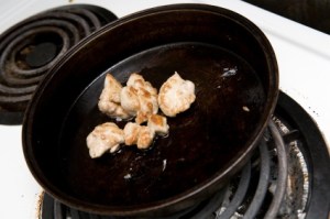 Seared lamb sweetbread in a skillet.